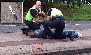 Knife-wielding thug is pinned down by police officers after a terrifying road rage attack on a father and his four young children